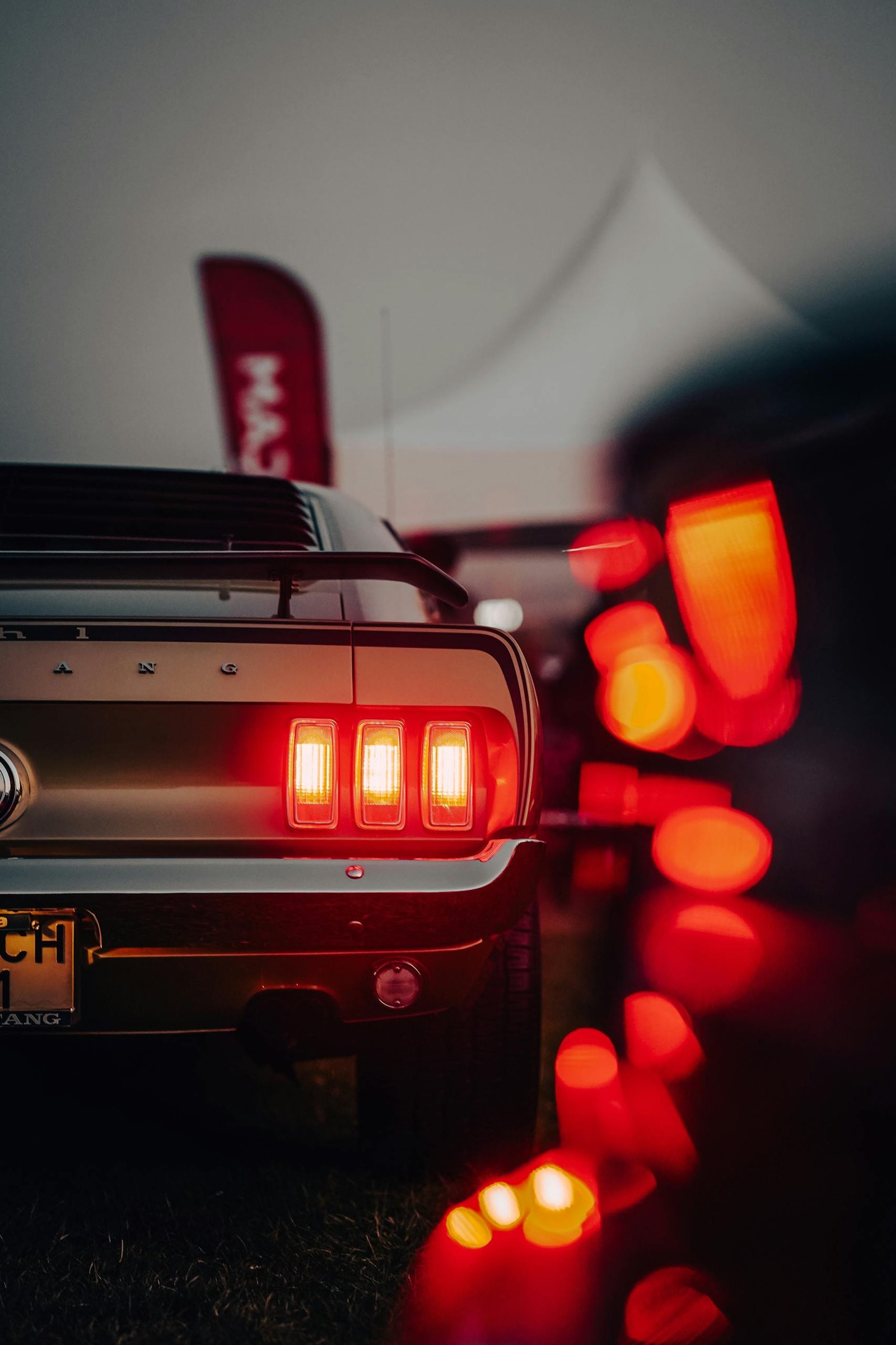 A sleek red hatchback car parked in front of a modern building, enhancing urban street aesthetic.